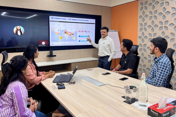 Team members participating in a collaborative meeting and presentation in a ZF office environment.