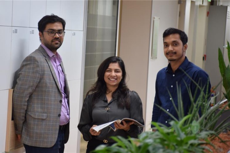 Early career professionals collaborating on business and strategy discussions in a corporate office environment