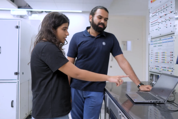 Engineering interns working on real-world projects with hands-on guidance in a technical lab environment