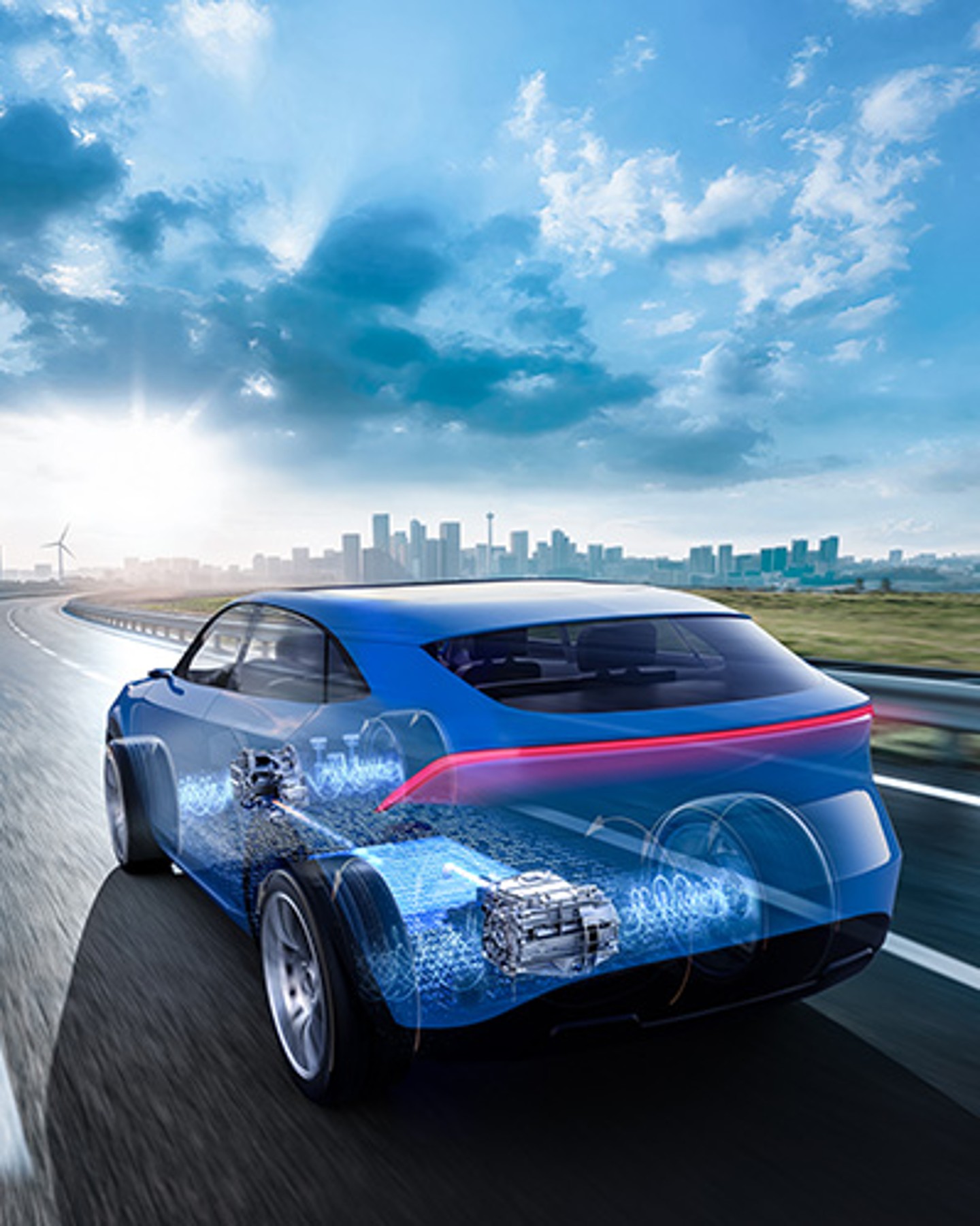 Gläsernes Elektroauto auf einer Landstraße mit sichtbar dargestelltem E-Antrieb und Hochvoltbatterie.