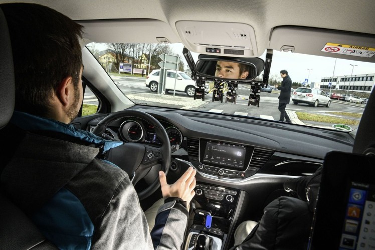Man crosses in front of vehicle at a crosswalk