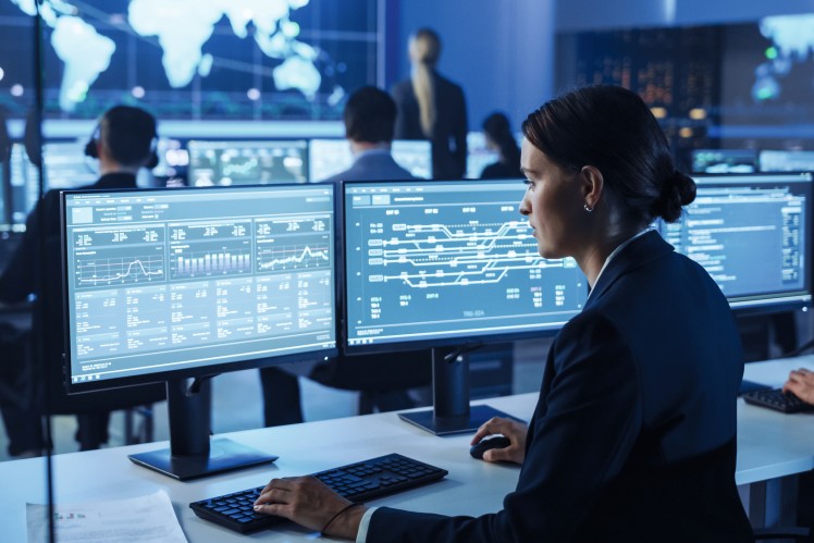 Person working at a computer with multiple screens