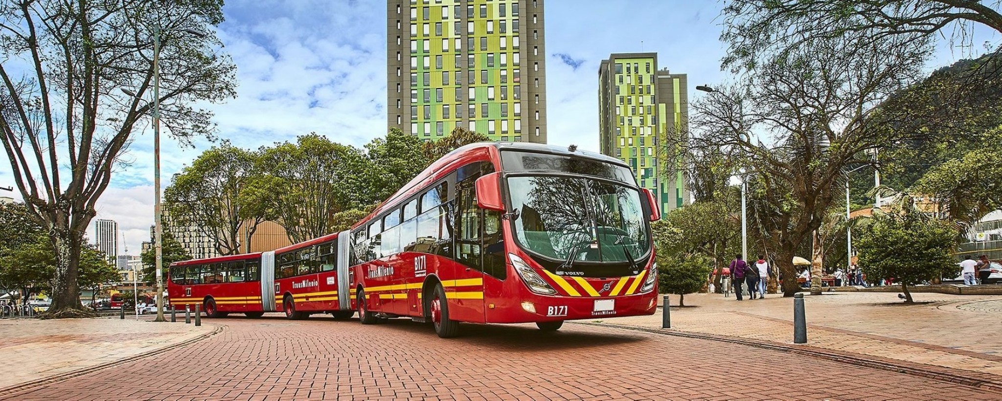 Burgundy and yellow articulated bus