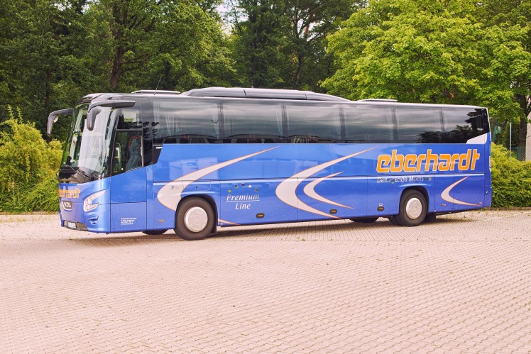 Blue coach in a parking lot