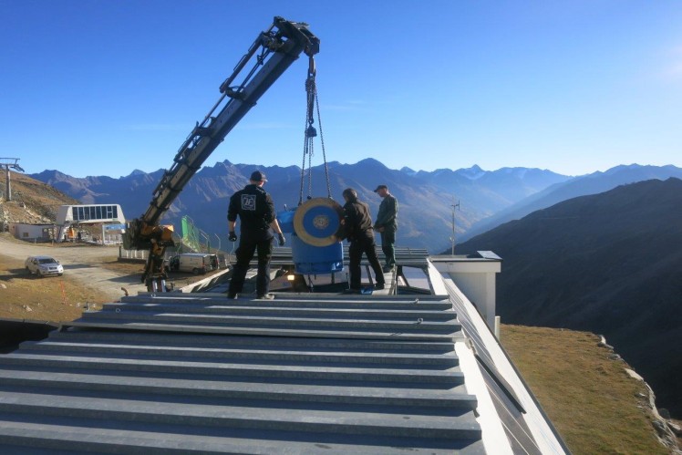 Service technicians on the roof of a moutain station 