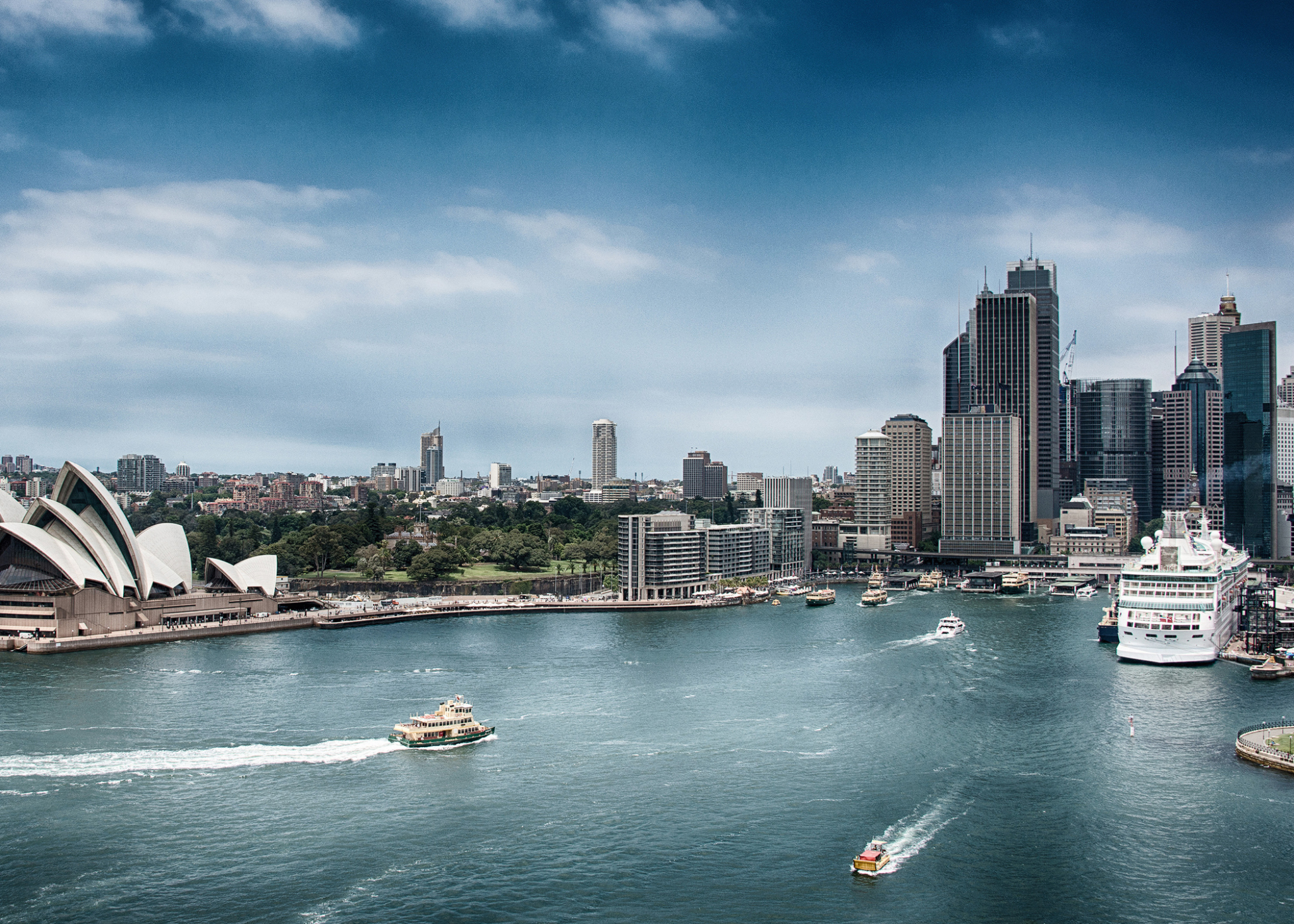 View of Sydney from the water with several boats in the foreground.