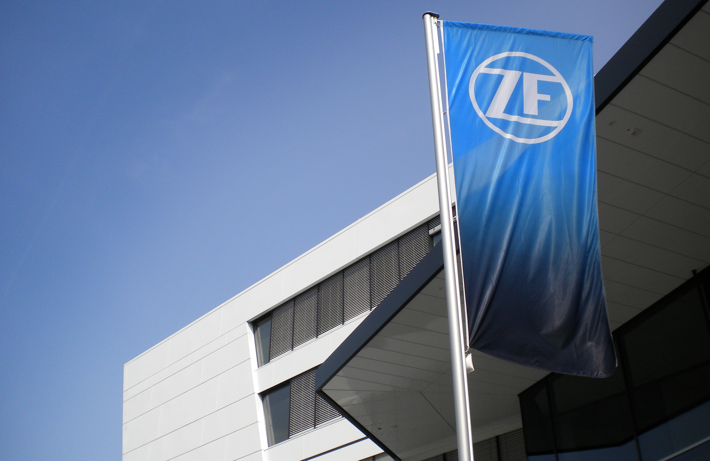 ZF blue flag in front of a building