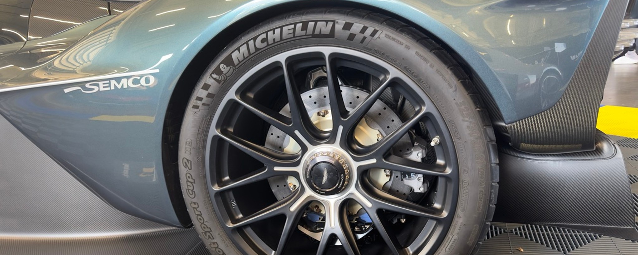 Wheel on blue vehicle showing brake disc