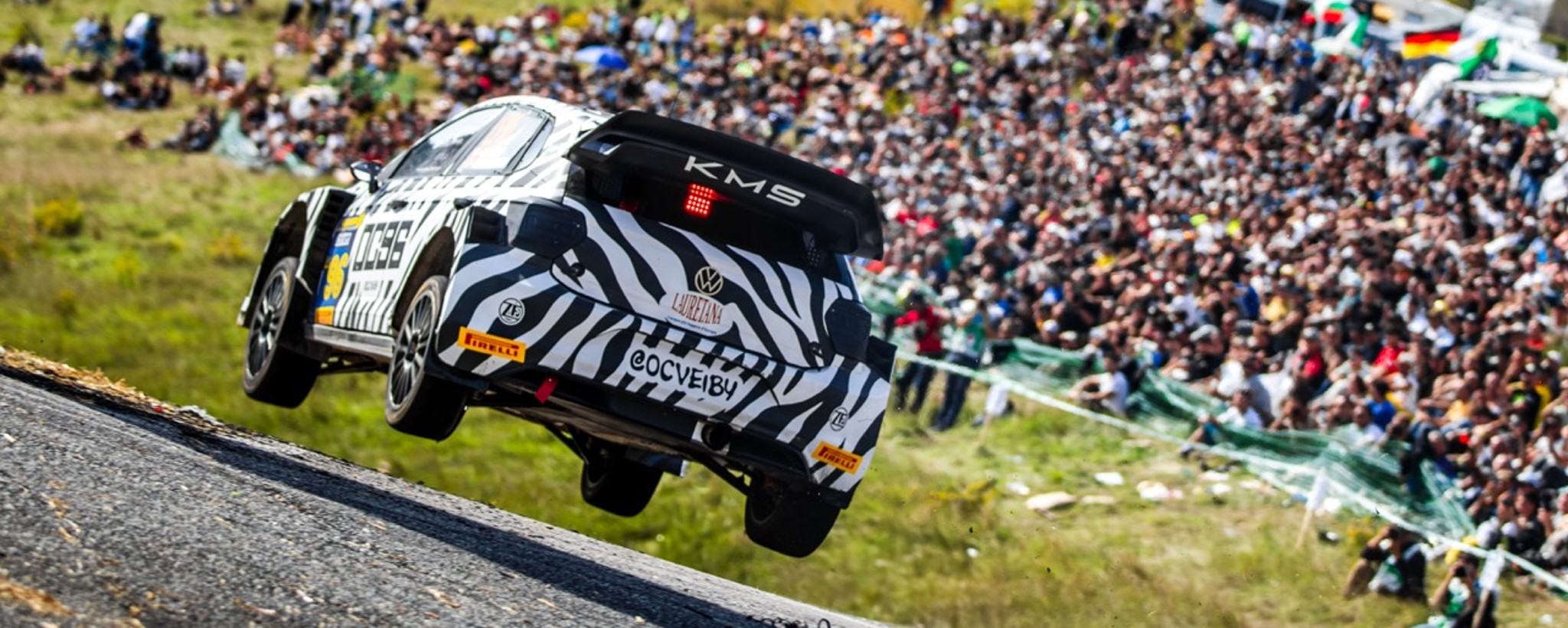 Car travelling at speed on track, tyres of floor