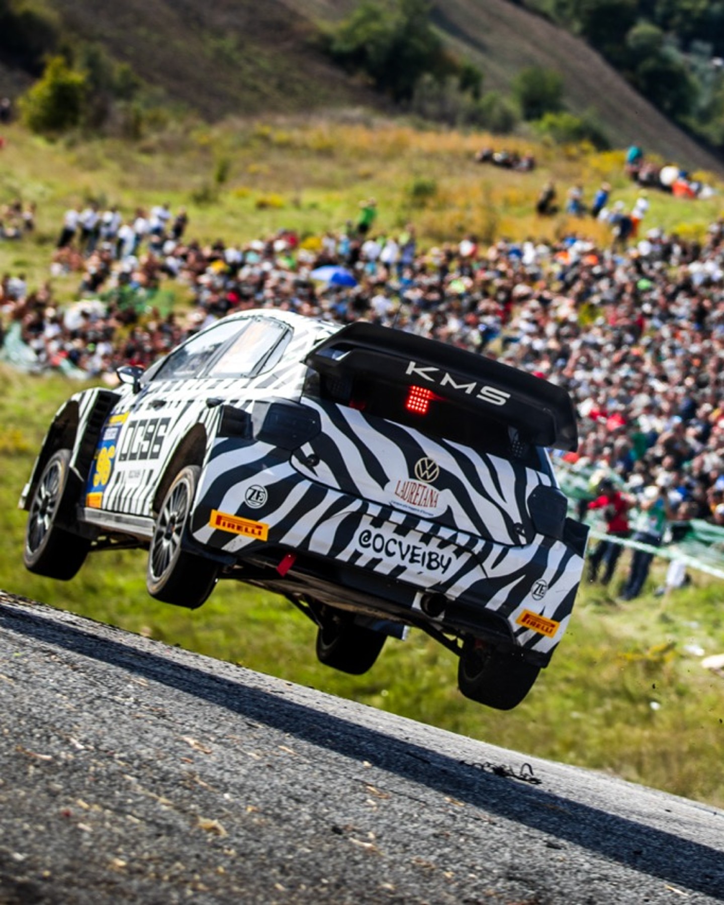 Car travelling at speed on track, tyres of floor