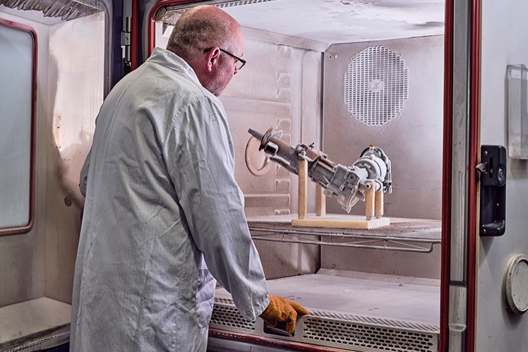 Person looking at product inside icing chamber with door open