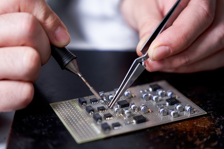 Engineer placing sample on microscope