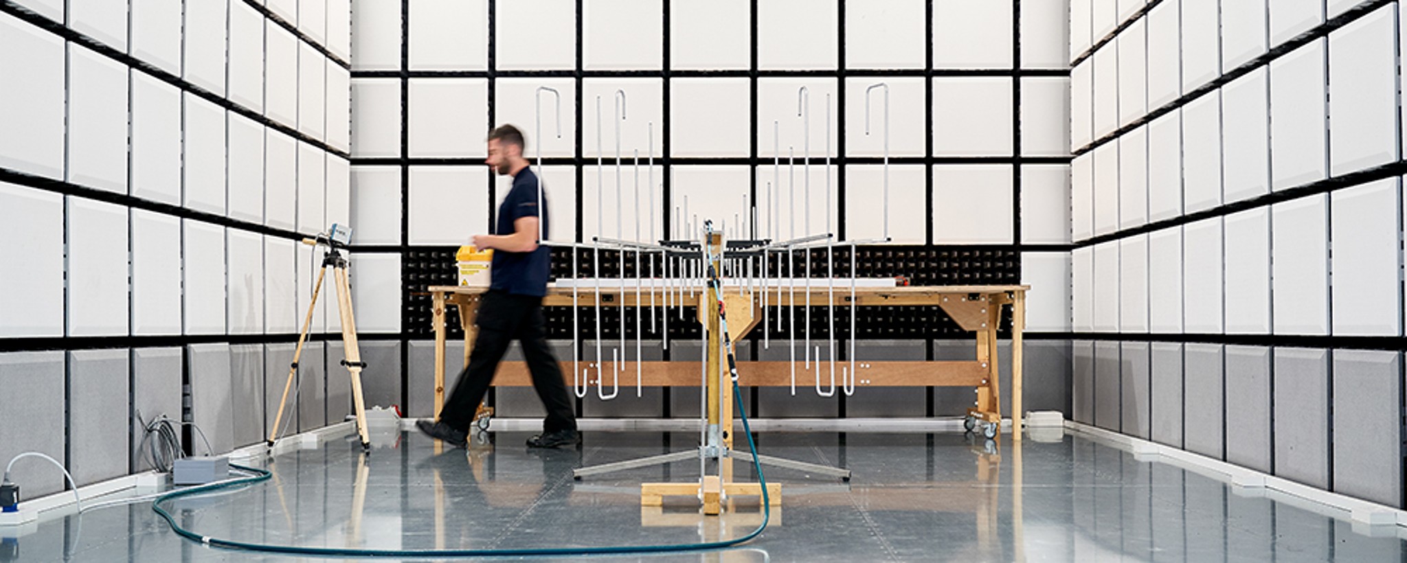 EMC chamber with person inside walking in background