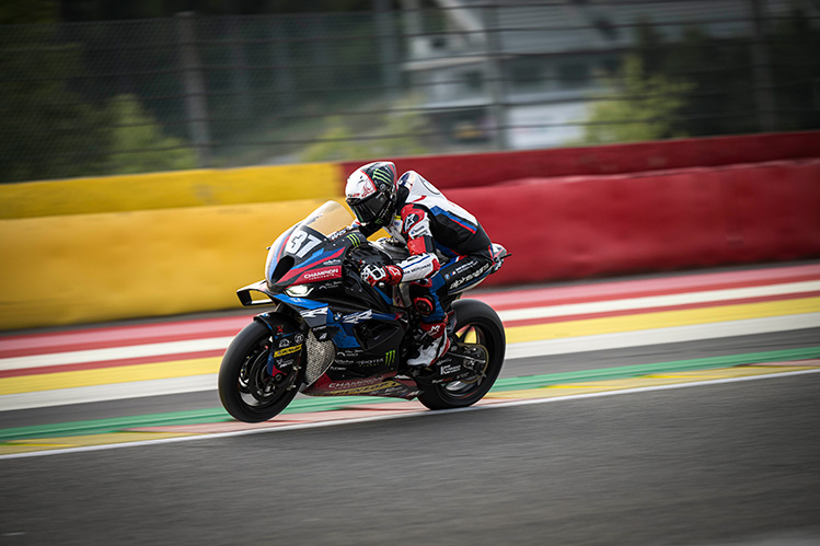 Motorbike travelling at speed on track, background blurred