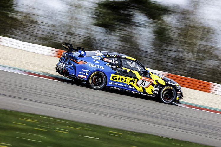 WS Racing car travelling at speed on race track, background out of focus