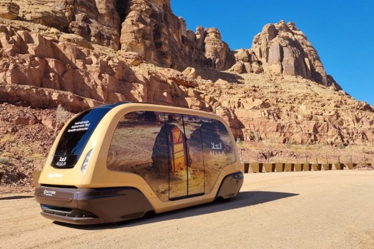Brown shuttle in front of mountains in the desert